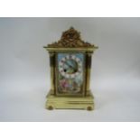 A Mid 19th Century French brass cased mantel clock with hand painted porcelain front panel depicting