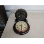 A GPO electric slave clock and a metal cased timepiece with visible pendulum and escape wheel on