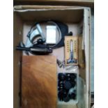 A box of mixed tools and equipment including mainspring winders, case openers, head visor and
