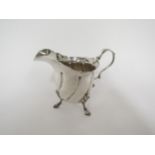 A Nathan Hayes silver cream jug with wrythen ribbed body, shell relief hoof feet, Chester 1899, 128g