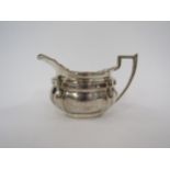 A Hamilton & Inches silver milk jug, stirrup handle, gilt interior worn, 8.5cm tall, Edinburgh 1911,