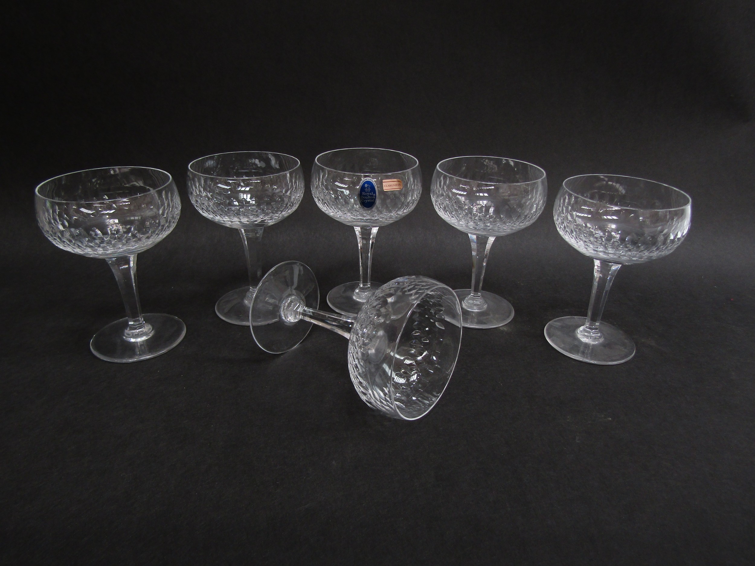 A set of six Royal Doulton crystal champagne saucers with cut detail