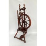 A George IV fruitwood spinning wheel, turned spindle spokes and supports