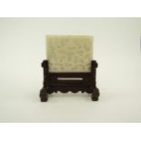 A Chinese white jade tablet / desk stand on hardwood stand, 11.5cm x 10cm with stand