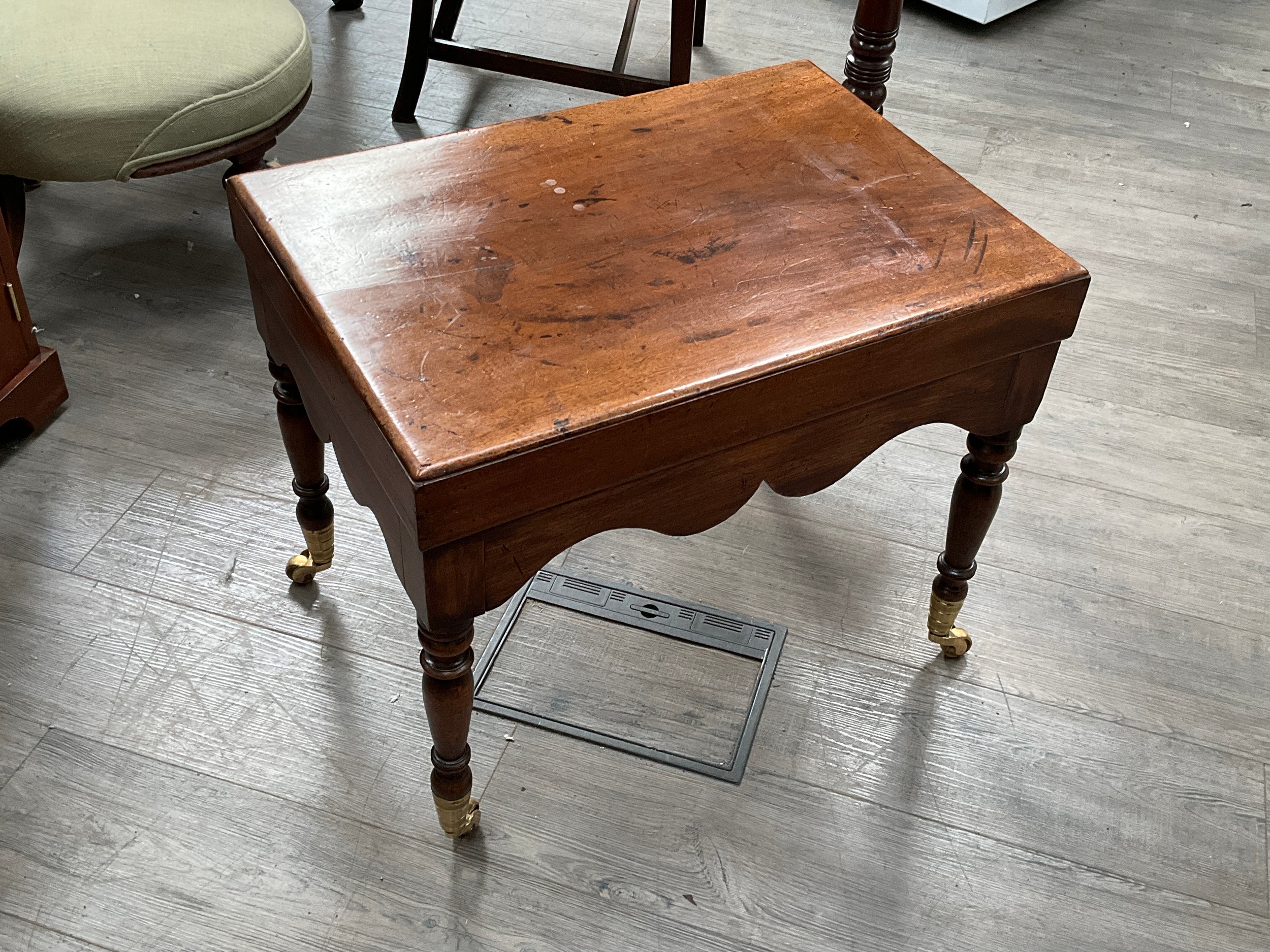 A 19th Century mahogany commode converted to a table with brass castors