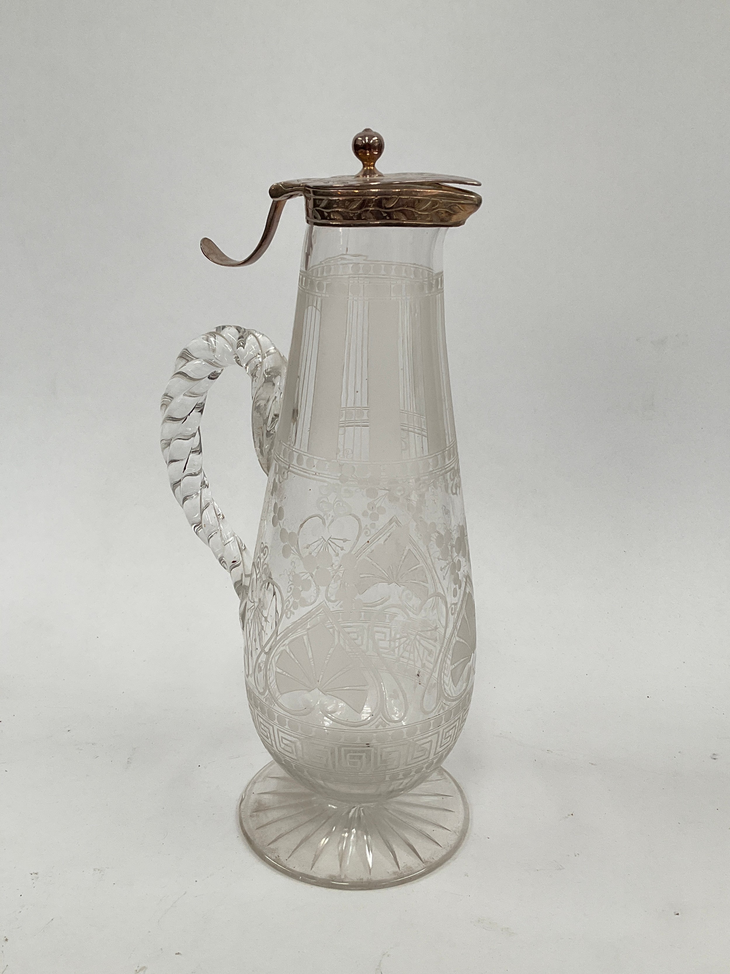 A Victorian etched crystal glass claret jug with rope twist handle, the top with Thompsons patent