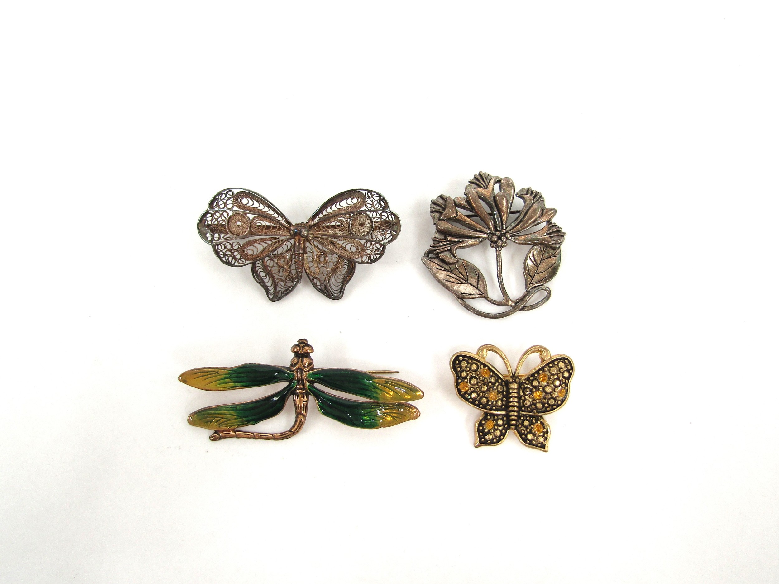 Four brooches including dragonfly, filigree moth, butterfly and MASJ floral spray dated 87