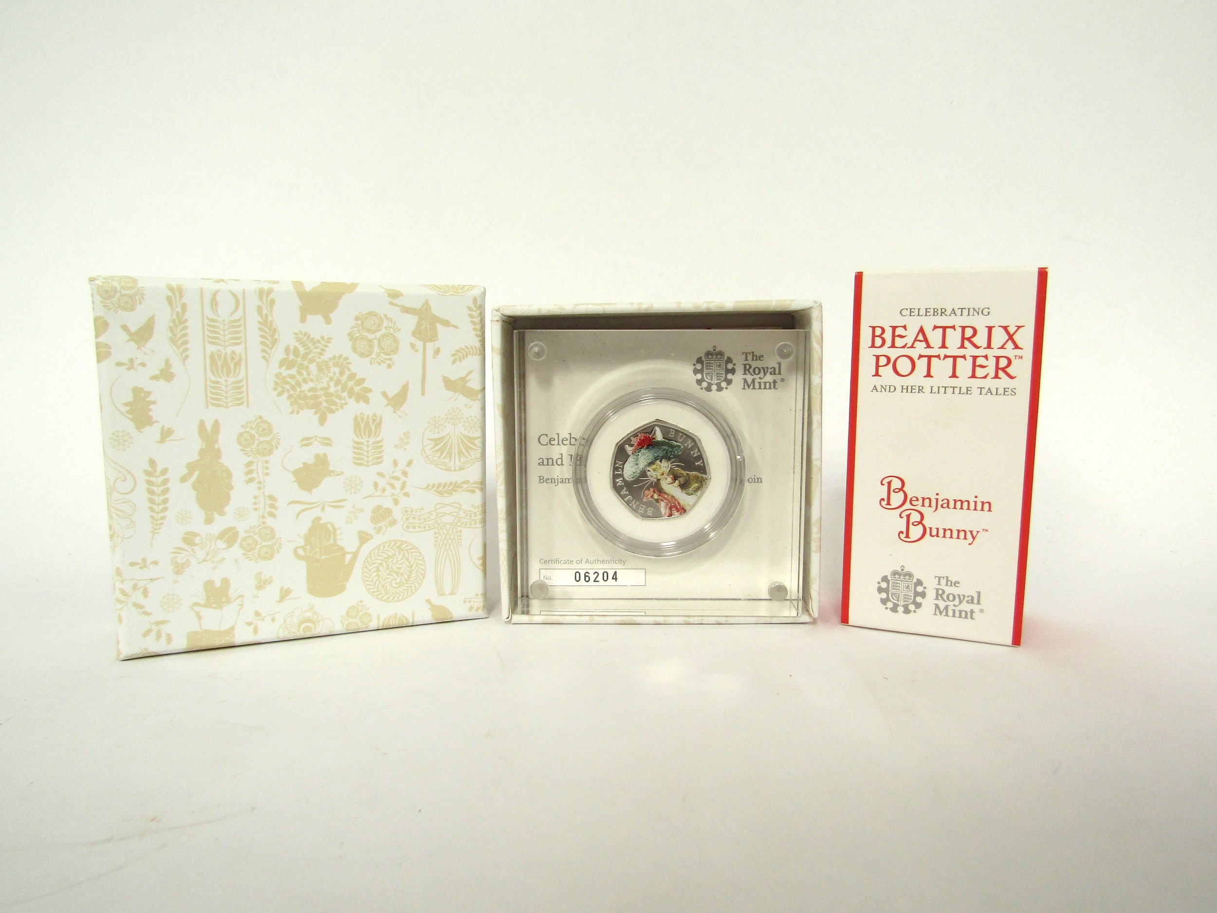 A Royal Mint Beatrix Potter Benjamin Bunny enamel 50p piece, cased with certificate, boxed