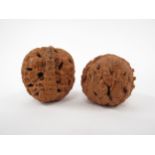 Two Oriental carved walnuts