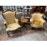 A pair of French lady's and gent's fireside armchairs, gilded carved wooden frames with scrolls