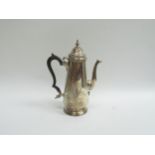 A Goldsmiths and Silversmiths Co silver coffee pot with circular base, Bakelite handle, London 1902,