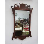 A late 19th Century walnut shaped mirror frame with plain glass mirror plate, 65cm x 39cm