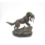 A bronze sculpture of a hunting dog with a pheasant in its mouth on marble base, bearing name,