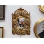 An 18th Century gilt wood mirror frame with replaced glass, 35cm x 24cm