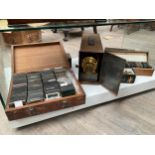 A Magic lantern and a collection of vintage glass Magic Lantern slides, themes include British Army,
