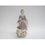 A late 18th/ early 19th Century Meissen porcelain figure of a lady, recumbent sheep at her feet.
