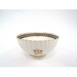 A George III Caughley porcelain slop bowl, fluted body with underglazed blue flowers, heightened