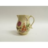 A Lowestoft 18th Century sparrow beak jug with floral motifs, discoloured and cracked, 9cm tall