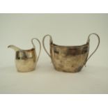 A Georgian silver twin handled sugar bowl, 19cm long and similar milk jug, London 1795, with split
