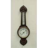 An oak wall hanging barometer