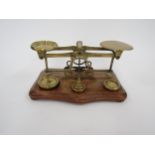 A set of brass postal scales with weight