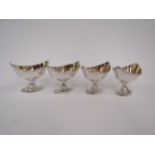 A set of four Robert Pinkney Georgian silver boat shaped table salts with gilded interiors,