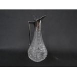A John Grinsell & Sons hobnail and thumb-cut crystal claret jug with silver handle and pourer,