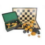 A 20th Century leather chess board together with chess pieces and draughts