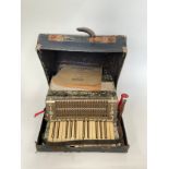 A Tonella circa 1930's-50's German squeezebox concertina accordian with original box and sheet music