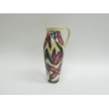 A Moorcroft ewer designed by Philip Gibson, with pink/purple flowers, No.148, 27.5cm tall
