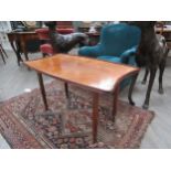 LAZZLO HOENIG - A shaped walnut top coffee table with reeded legs to brass cup feet, 54cm high x