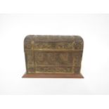 A circa 1900 gilt brass embossed domed top letter box, the lid opening to reveal sectional oak