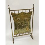 An Edwardian Art Nouveau brass fire screen with fish and floral detail
