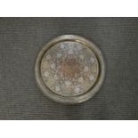 An Arabic charger/table top with copper, brass and silvered decoration, 69cm diameter
