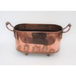 A copper twin handled jardinière applied with leaves raised on feet 43cm long x 26cm deep