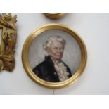 A 20th Century oil on canvas board of elderly lady in circular gilt frame, unsigned, 23cm diameter
