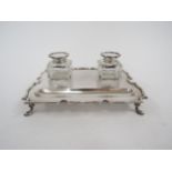 A Goldsmiths and Silversmiths Company silver desk stand set with double glass inkwells, square