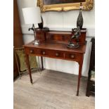 An Edwardian crossbanded mahogany writing table the raised back with fitted stationery compartment