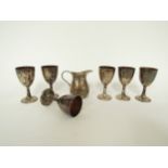 A set of six miniature white metal gilt goblets stamped 800, 6.5cm tall and a silver miniature