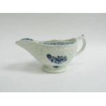 A Lowestoft blue and white sauce boat, Circa 1760-70 with moulded sides, flower cartouche and