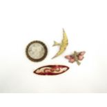 Four decorative brooches including fairy, swallow, flamingo and floral