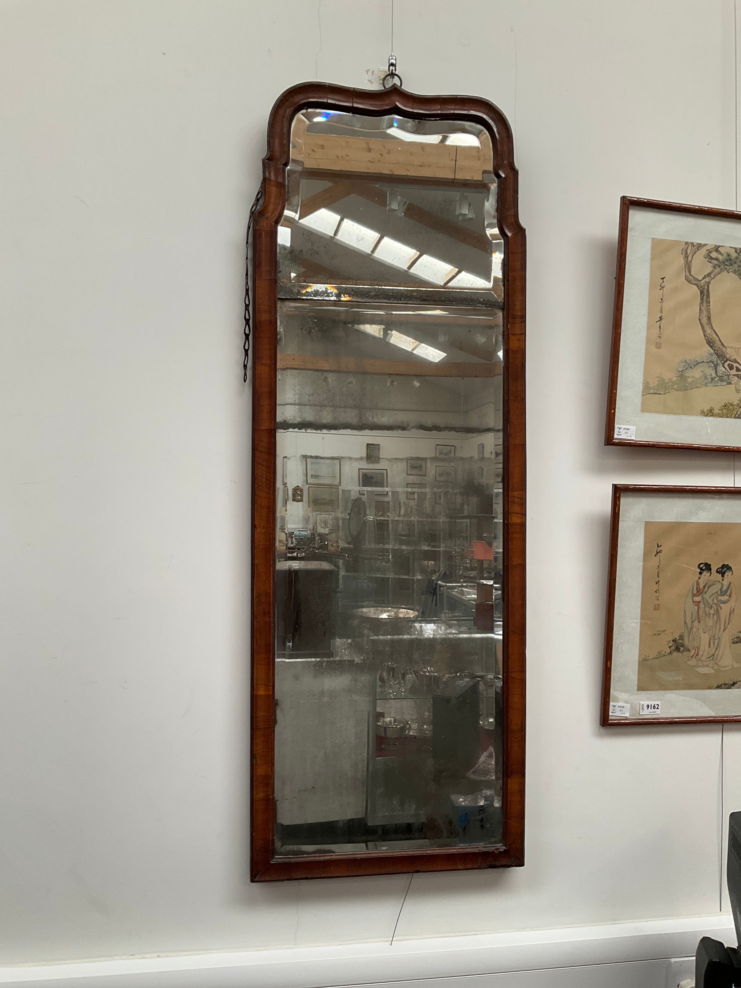 An early mid 18th Century walnut wall mirror, bevelled original glass in two sections