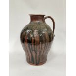 A large pottery vessel with single handle, drip glaze to body, 39cm tall