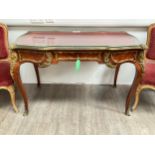 A Louis XVI style French Kingwood writing table with inset leather top, ornate ormolu mounts,