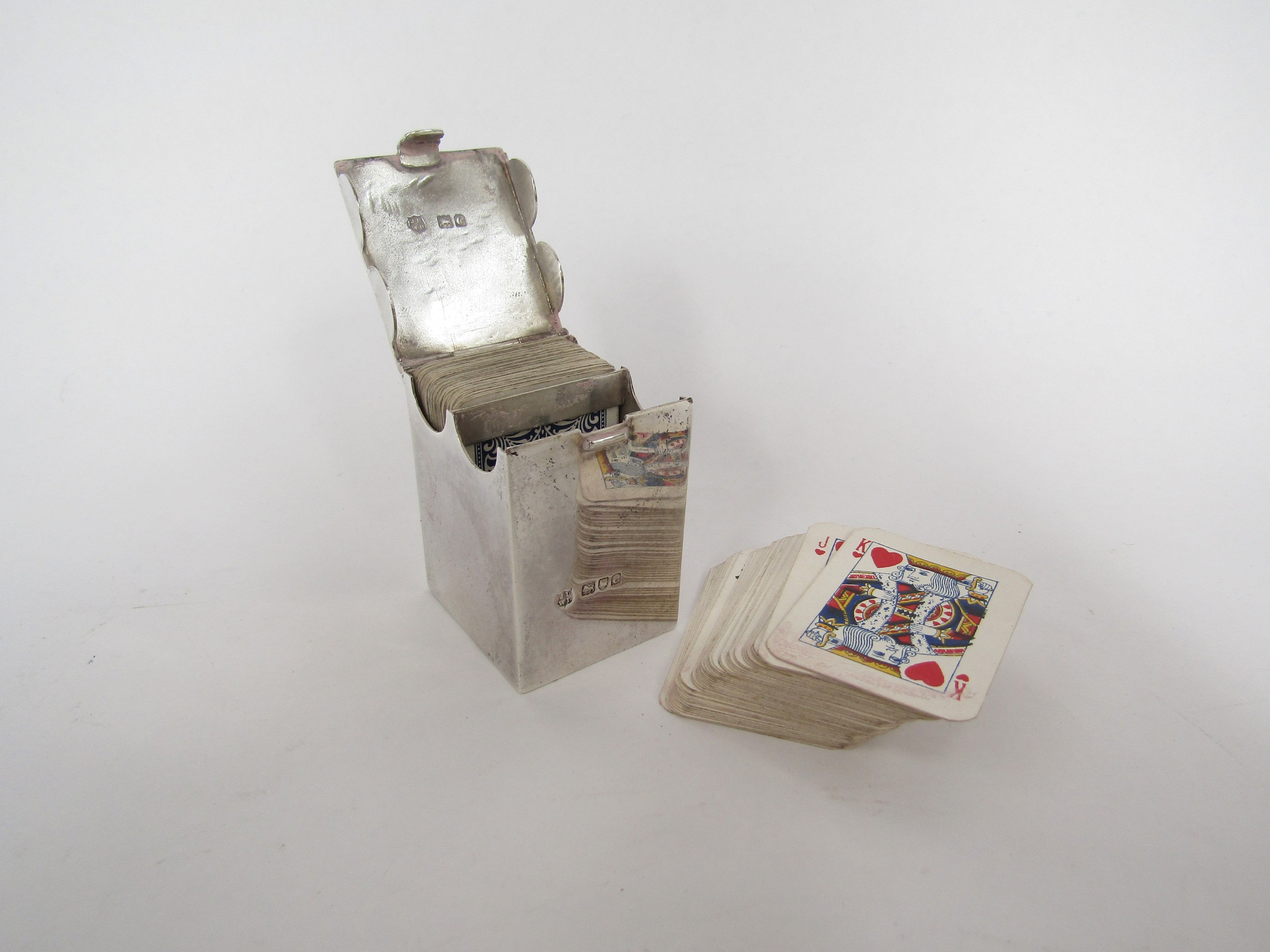 A John William Deakin silver playing card box, the lid opening to reveal two sections with miniature