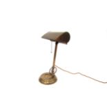 A brass desk lamp with pull chain, marked