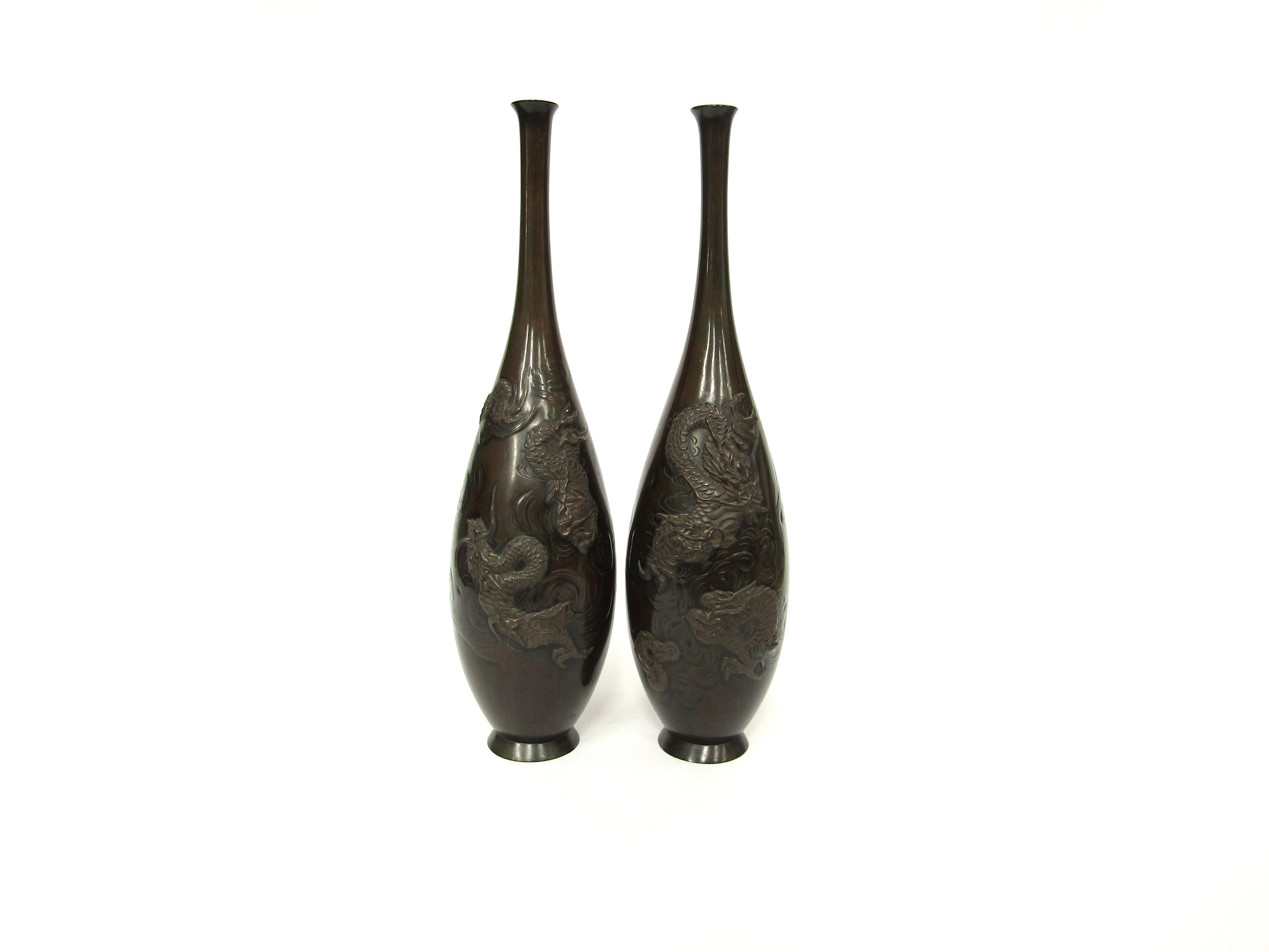 A pair of Japanese bronze vases with applied stylised dragons, 37cm tall