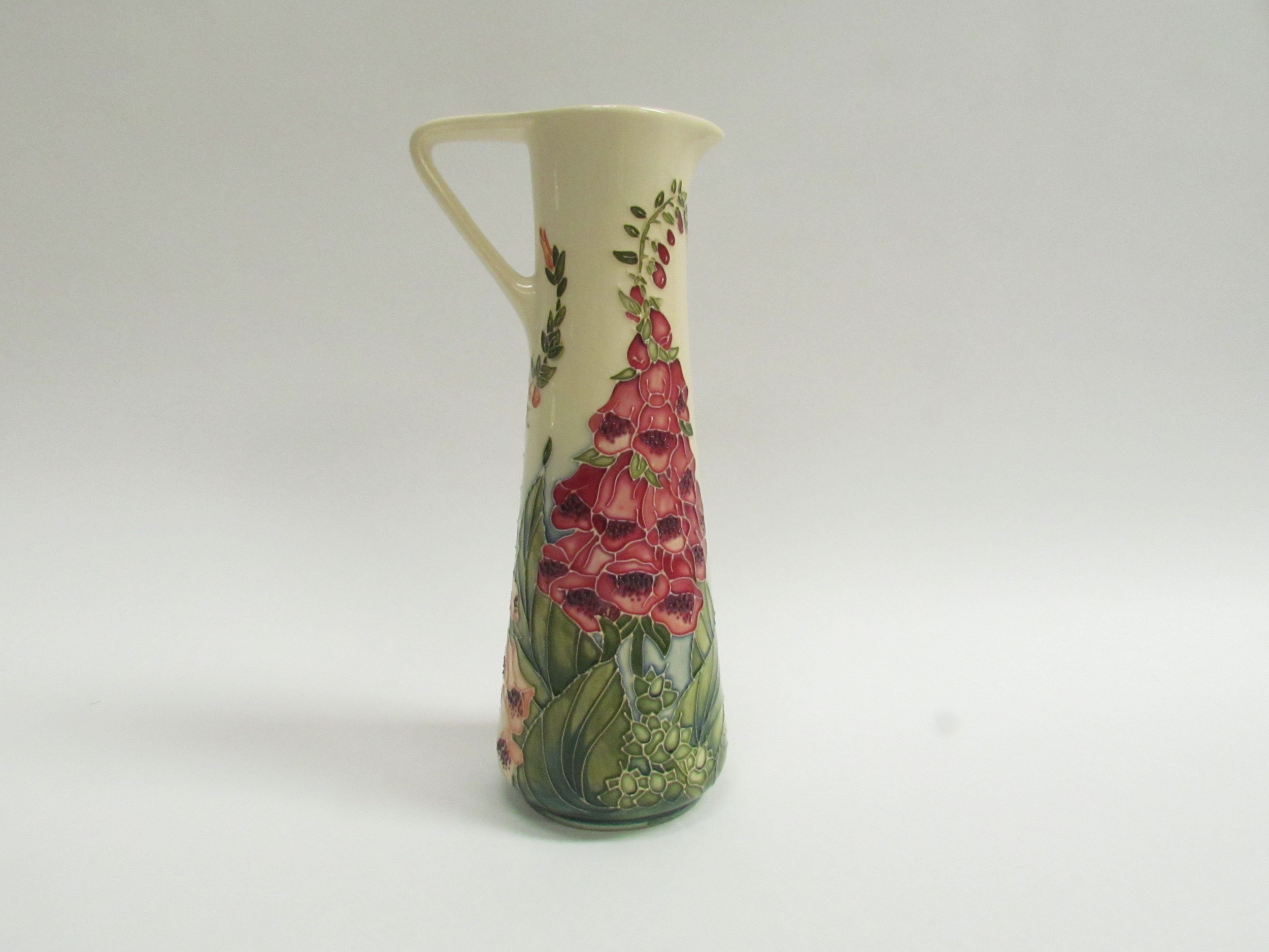 A Moorcroft Foxglove pattern slender jug by Rachel Bishop No.420 (crazing to cream ground) 24.5cm