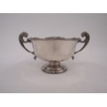 An Adie Bros silver twin handled pedestal bowl, shaped edge with foliate motif, scroll handles