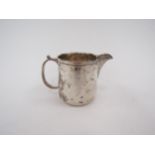 A silver milk jug, London 1926. marks rubbed, 7cm tall, 102g
